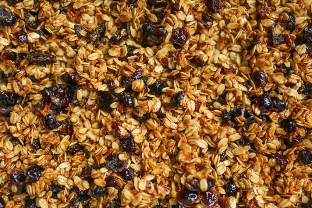 Close-up of homemade granola with oats and raisins, showcasing a healthy snack option.